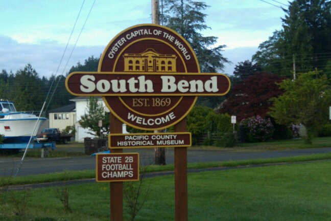 An image of the official South Bend Signpost which proudly proclaims South Bend to be the Oyster Capital of the World.