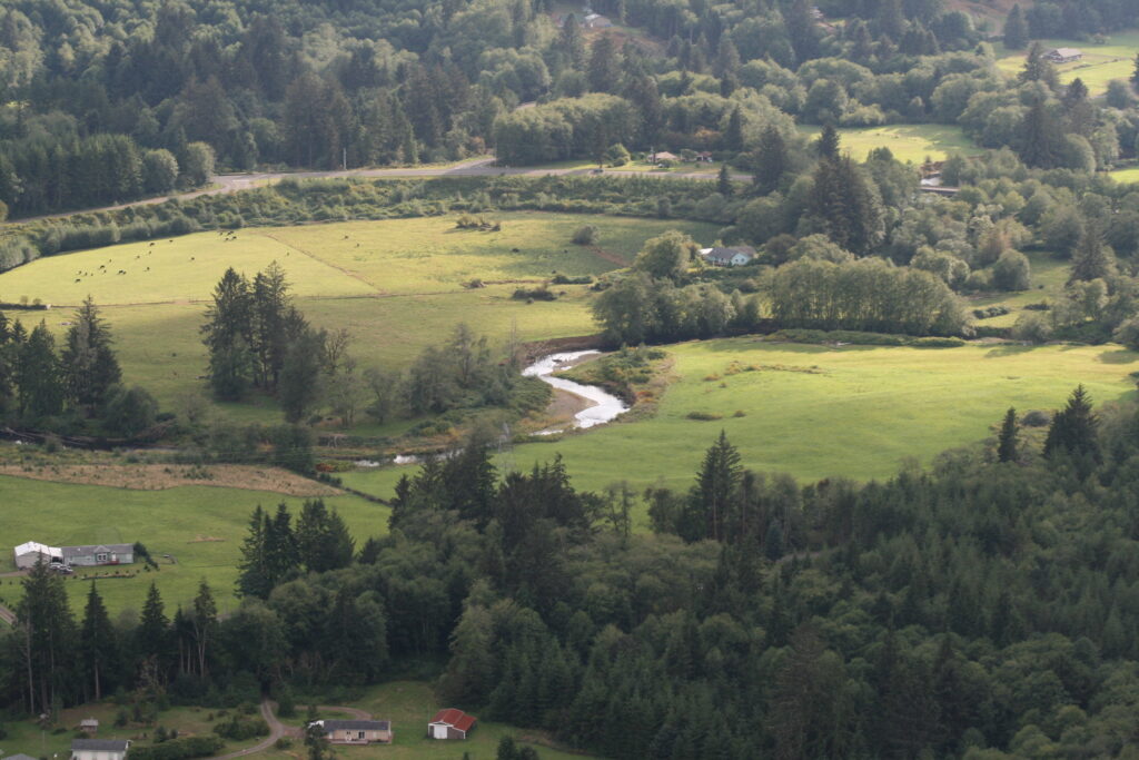 An aerial view of Naselle Roac, which is flanked on both sides by gorgeous verdant hills and valleys.