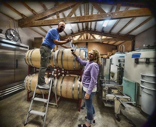 WooHoo Winery - Owners Pulling Sample of Wine.
