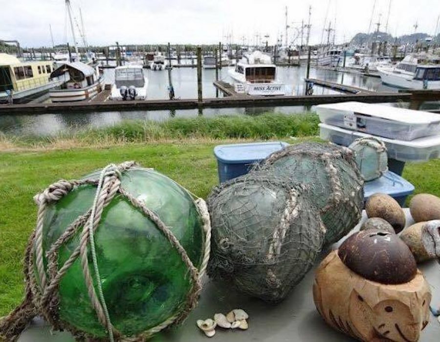 An Image of large glass floats set ashore, the netting still affixed around them.