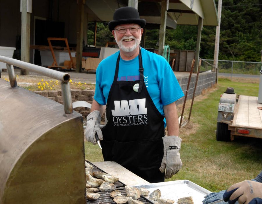 An image of two locals grilling oysters on their barbeque.