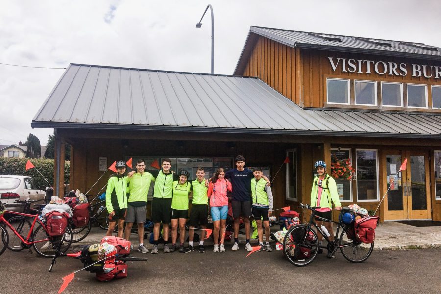 An Image of a group of young, teenage cyclers gathered in front of the Visitor Center.