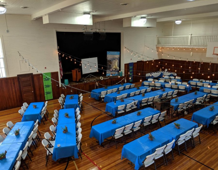 Image of a banquet hall temporarily set up within a gymnasium.