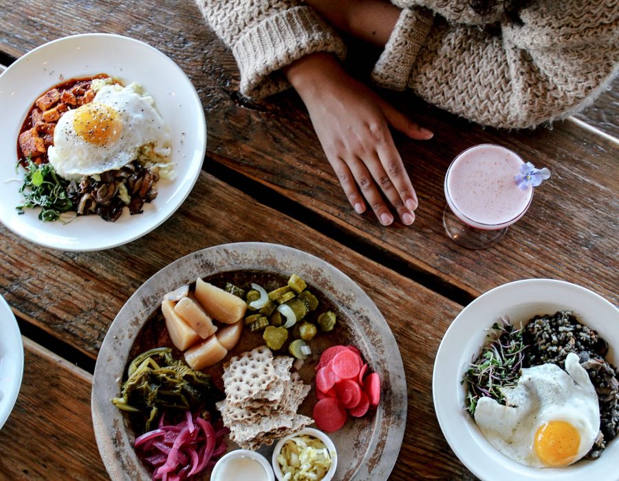 A tasty image of various dishes and local cuisines all artfully placed together on a table.